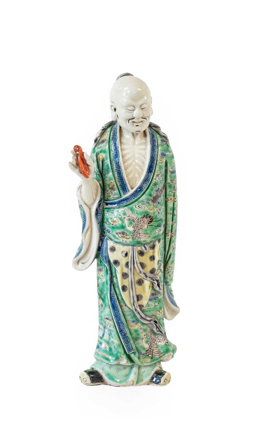 Lot 29 - A Chinese Porcelain Figure of an Immortal,...