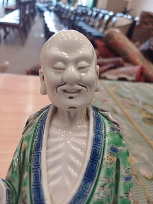 Lot 29 - A Chinese Porcelain Figure of an Immortal,...
