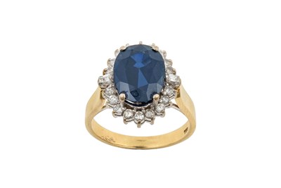 Lot 2202 - A Sapphire and Diamond Cluster Ring the oval...