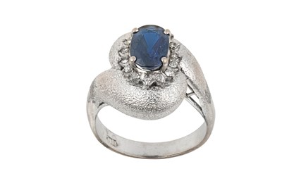 Lot 2340 - A Sapphire and Diamond Twist Ring the oval cut...