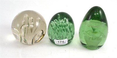 Lot 174 - Two green glass dump paperweights and another paperweight