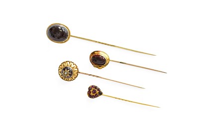 Lot 219 - Four Garnet Stick Pins, comprising of two oval...