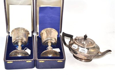 Lot 194 - Embossed silver tea pot and a pair of silver commemorative goblets, cased