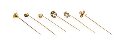 Lot 235 - Six Stick Pins, including a sapphire and...