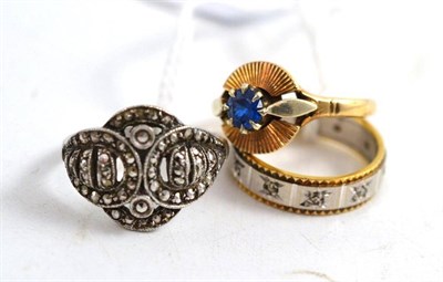 Lot 214 - An 18ct gold eternity ring; marcasite ring; and a 9ct gold and blue stone set ring (3)