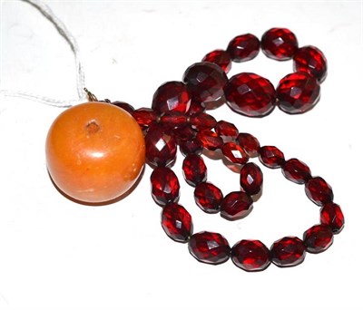 Lot 217 - A necklace and a large amber bead