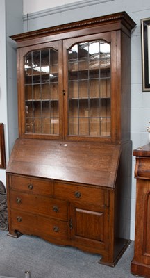 Lot 1242 - An Arts & Crafts Oak Bureau Bookcase, with...