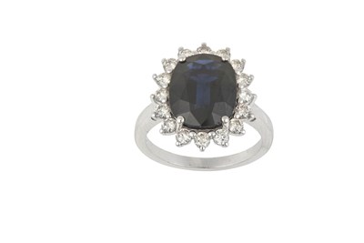 Lot 2366 - A Sapphire and Diamond Cluster Ring the oval...