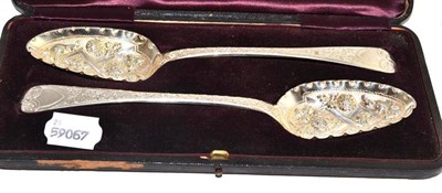 Lot 237 - A pair of George III silver berry spoons, cased