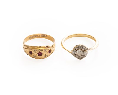 Lot 304 - A Diamond Three Stone Twist Ring, finger size...