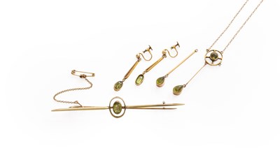 Lot 324 - A Peridot Bar Brooch, stamped '9CT', length...