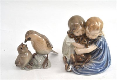 Lot 291 - A Royal Copenhagen group of two children and a puppy, and a Bing and Grondahl bird group (2)