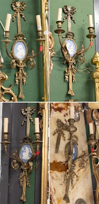 Lot 1196 - A Set of Four Brass Twin Light Wall Sconces,...