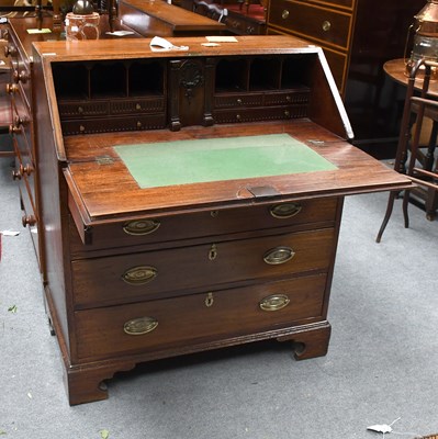 Lot 1324 - A George III Mahogany Bureau, with carved...
