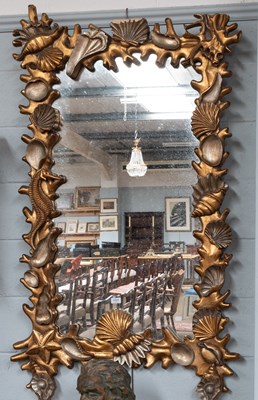 Lot 1424 - A Carved Giltwood and Silvered Oceanic Themed...