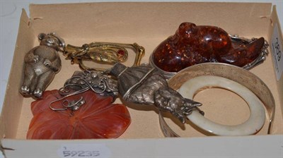 Lot 369 - A silver rabbit baby's rattle and another; an agate and amber type pendant; tape measure bangle...