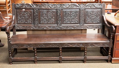 Lot 1334 - A Victorian Oak Settle, in 17th century style,...
