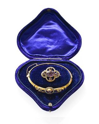 Lot 215 - An Amethyst and Split Pearl Hinged Bangle,...