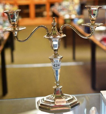 Lot 424 - A silver branched candelabra in the Georgian style, London 1950, on canted rectangular base,...