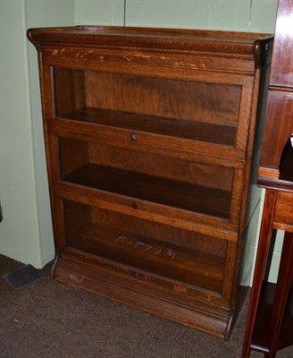 Lot 439 - An oak Globe Wernicke style three section bookcase