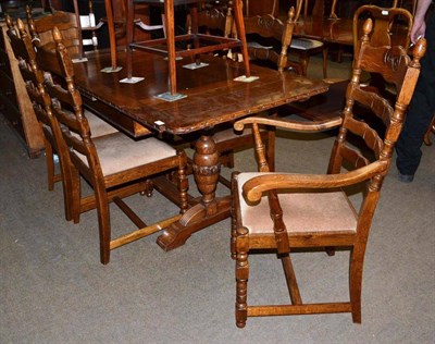 Lot 453 - An oak draw leaf table with a set of six ladder back chairs