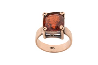 Lot 2358 - A Garnet Ring the cushion cut hessonite garnet...