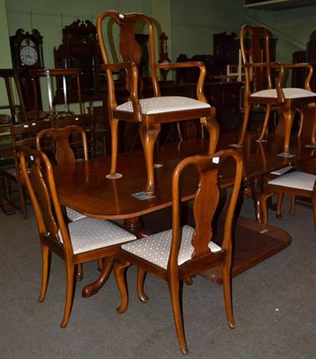 Lot 462 - Walnut pedestal table and a set of eight walnut chairs