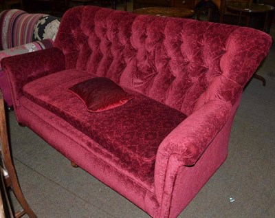 Lot 493 - Button back sofa, upholstered in deep red velvet