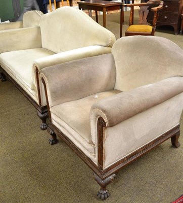 Lot 517 - An early 20th century three piece suite with caved mahogany frame with paw feet