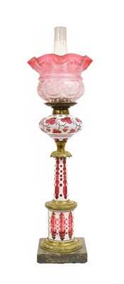 Lot 87 - A Bohemian White Overlay Cranberry Glass Oil...