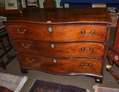 Lot 547 - A Georgian mahogany serpentine front three height chest of drawers