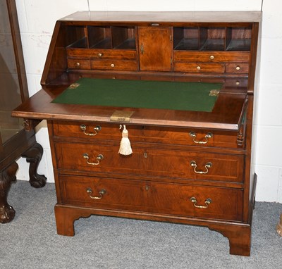 Lot 464 - A George III Walnut Bureau, cross and feather...