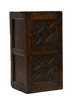Lot 494 - A Carved Oak Two Door Cupboard, the boarded...