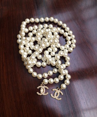 Lot 1071 - Chanel, A Faux Pearl Lariat Necklace with Two...