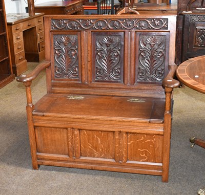 Lot 548 - A 20th Century Carved Oak Box Settle, 106cm by...
