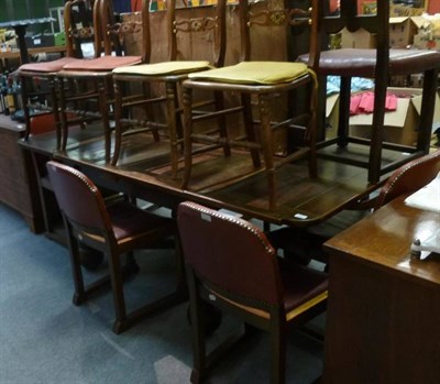 Lot 629 - A 1930's/40's oak draw leaf dining table and a set of six chairs and a pair of oak dining...