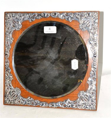 Lot 4 - An oak and silver applied mirror