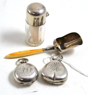Lot 15 - Two silver sovereign holders, silver caddy spoons and a silver topped bottle (4)