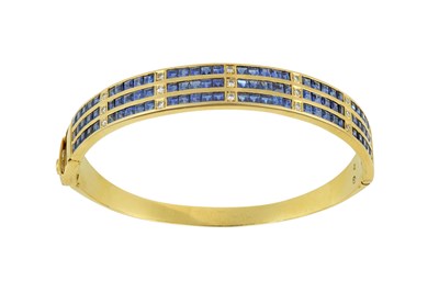 Lot 2229 - A Sapphire and Diamond Hinged Bangle three...