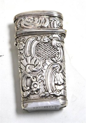 Lot 33 - An 18th century silvered metal etui, the exterior with embossed decoration in the Rococo...