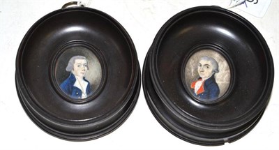 Lot 46 - A pair of late 18th century miniatures on ivory, each painted with a gentleman in a blue tunic