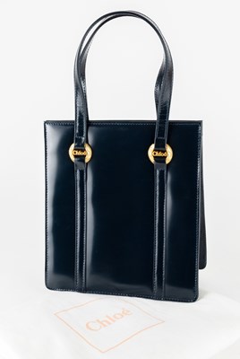 Lot 1036 - A Chloé Navy Leather Hand Bag, with brass-tone...