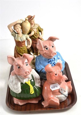Lot 82 - A pair of Royal Dux figures and three Wade pigs