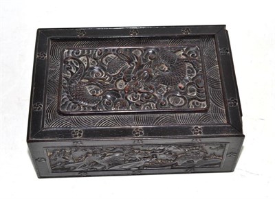 Lot 86 - A Chinese carved hardwood box, the lid carved with a dragon, the sides carved with figures of...