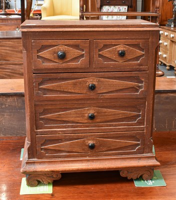 Lot 1264 - A Miniature Oak Chest of Drawers, with...