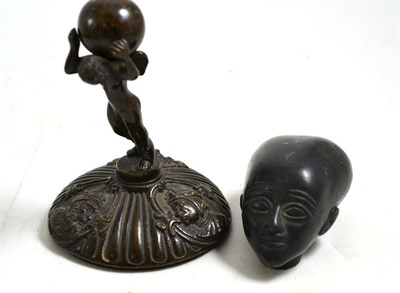 Lot 110 - Bronze figure of Atlas and a carved African head
