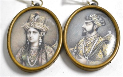 Lot 113 - A pair of Indian oval portrait miniatures, 19th century, painted with bust portraits of a...