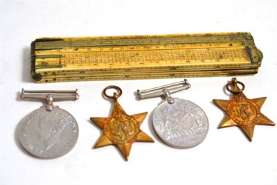 Lot 120 - An early 20th century brass and ivory folding rule and World War II medals