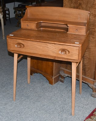 Lot 1352 - An Ercol Elm Windsor Desk, with three drawers...