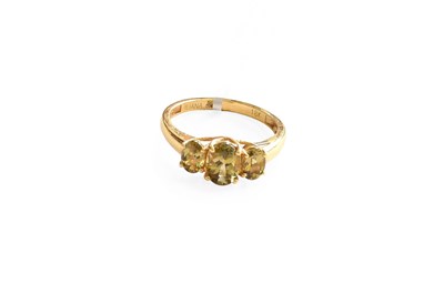 Lot 456 - An 18 Carat Gold Golden Tanzanite Three Stone...